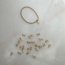 Load image into Gallery viewer, Gold cuban link bracelet with diamond pavé initial charm and extra charms