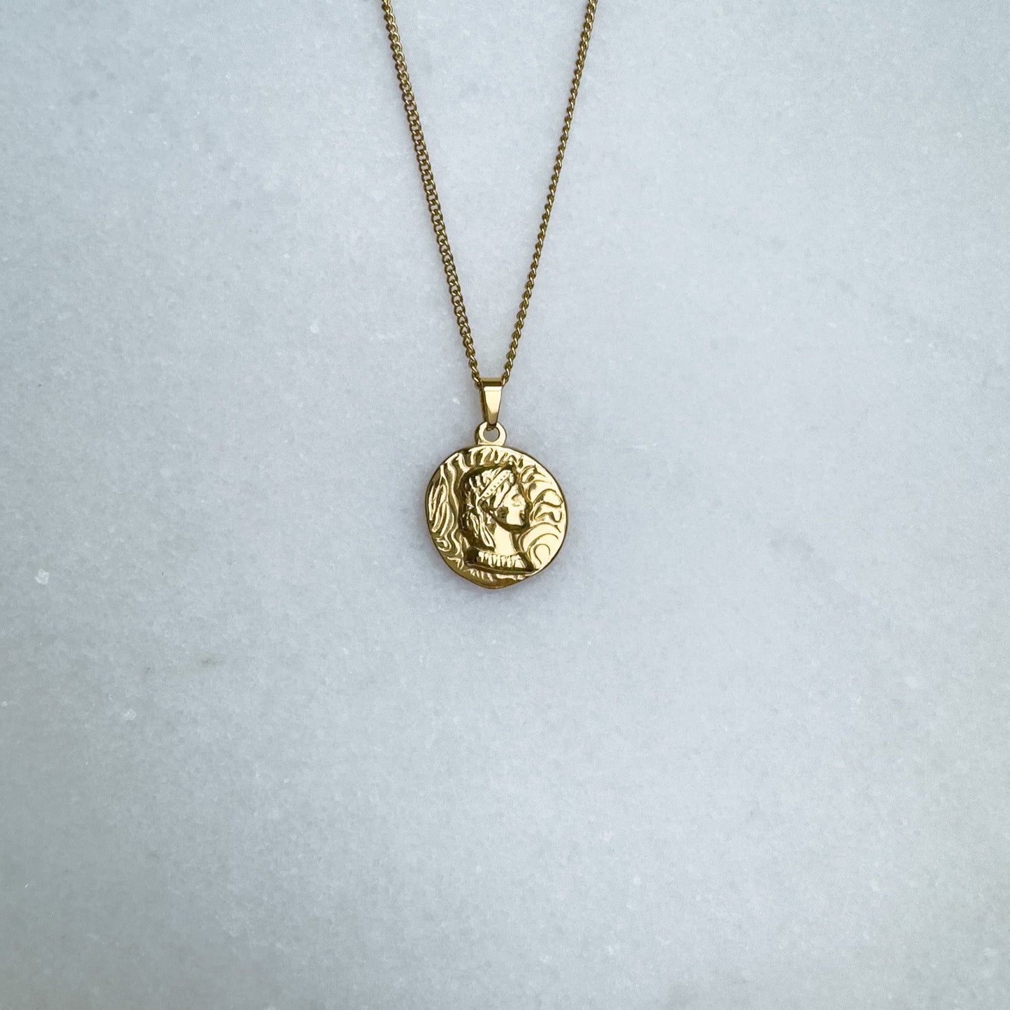 Gold chain with Native American coin pendant