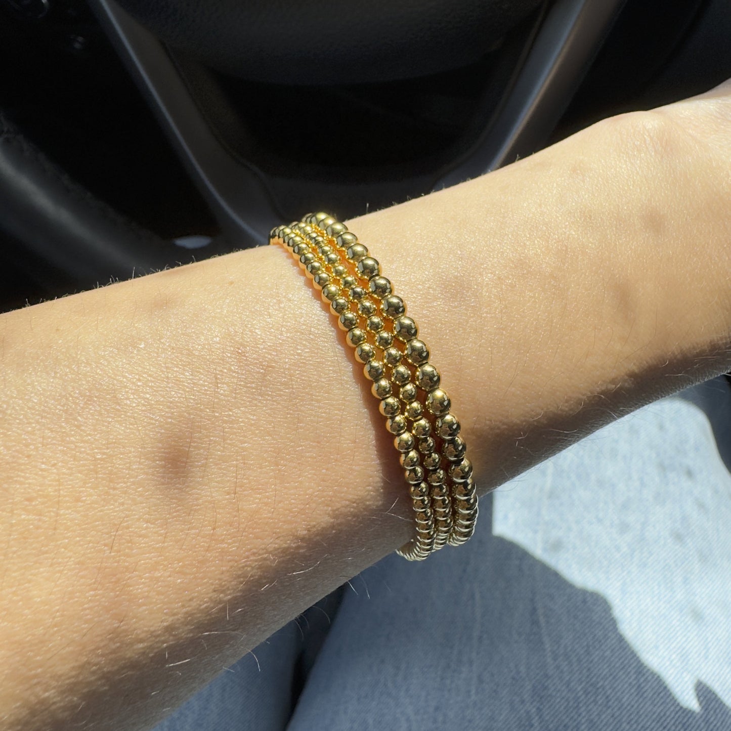 Gold beaded bracelet set on a wrist
