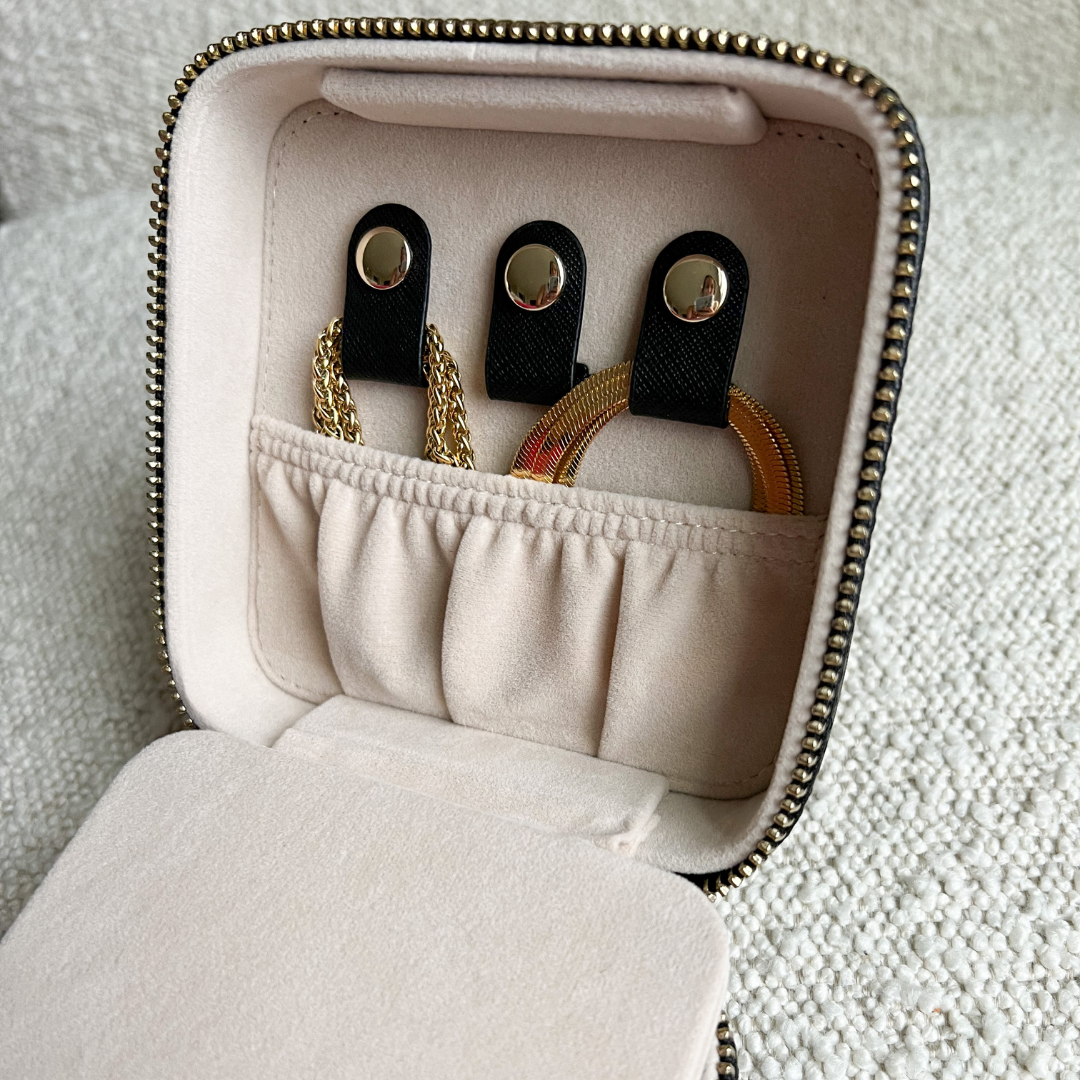 Open 4 inch x 4 inch Black Saffiano Leather Jewelry Travel Case with Gold Zipper Hardware filled with jewelry