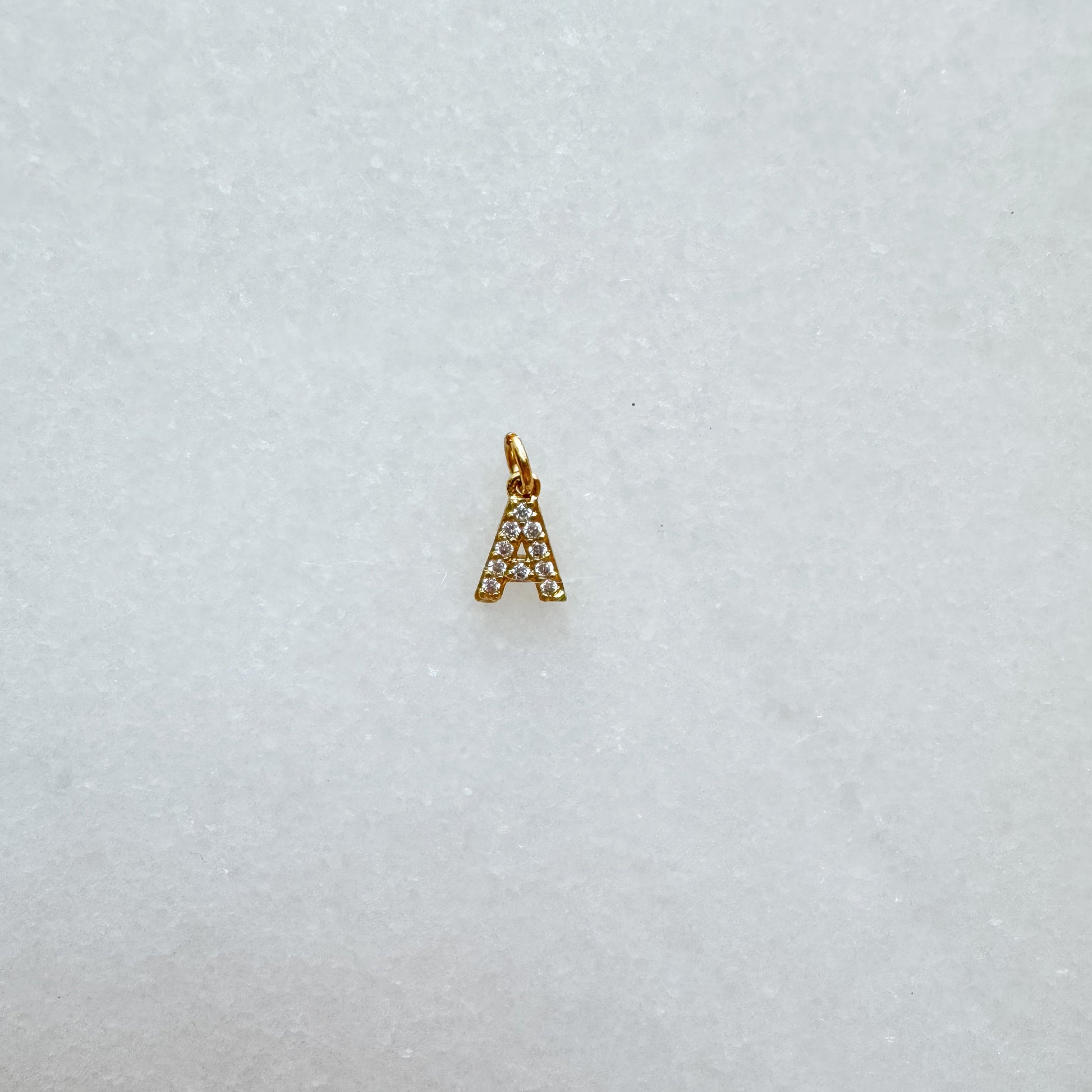 Diamond pavé initial charm set in gold, letter A