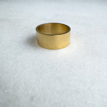 Load image into Gallery viewer, Gold metal band on a textured white background
