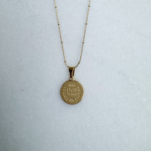 Load image into Gallery viewer, Gold necklace with a round pendant on a light gray background
