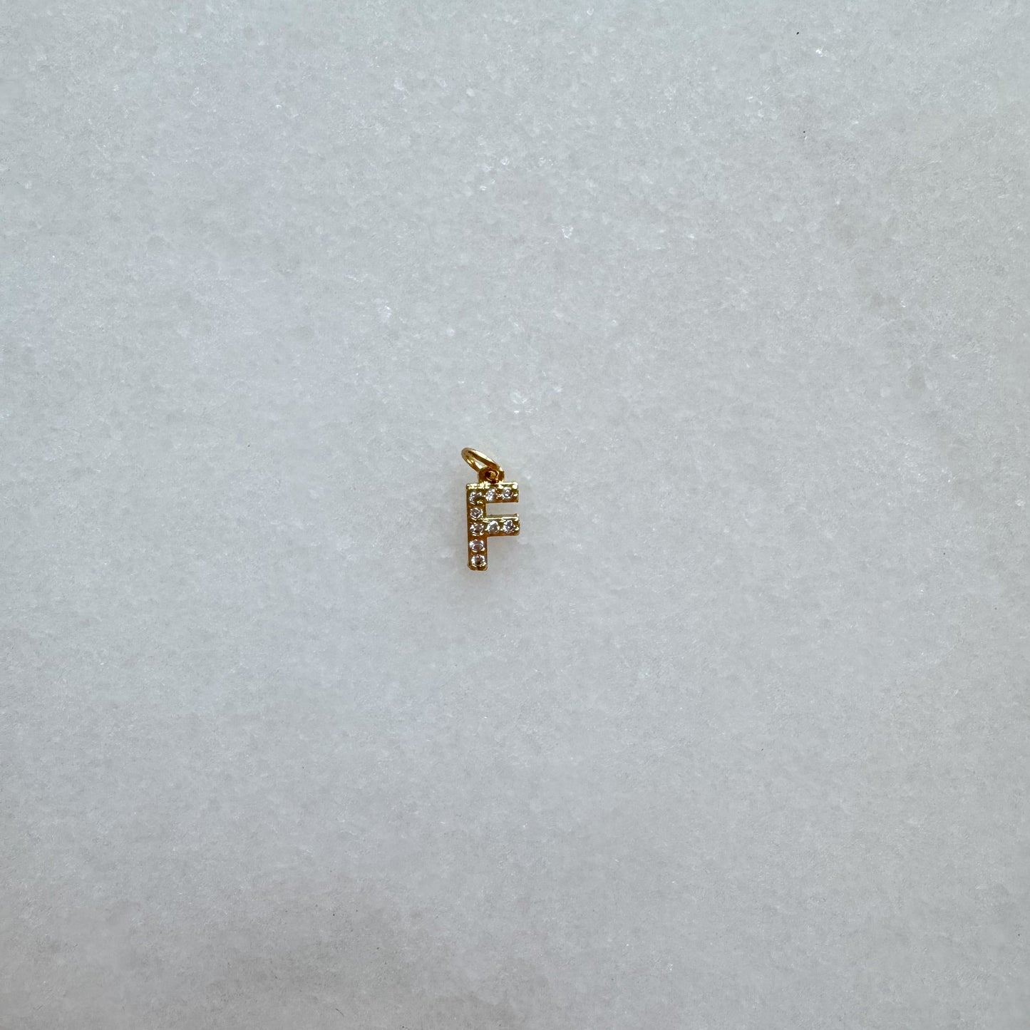 Diamond pavé initial charm set in gold, letter F