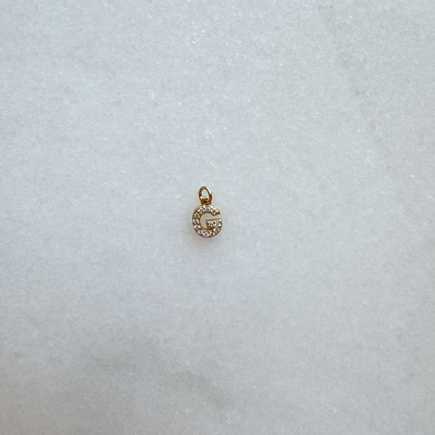 Diamond pavé initial charm set in gold, letter G