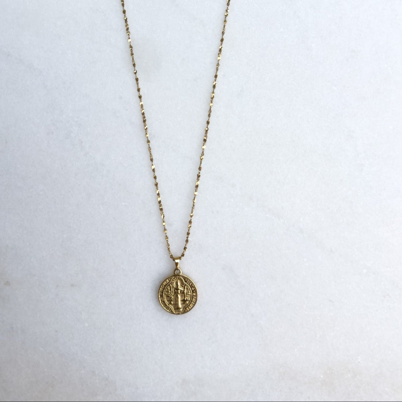Gold necklace with large coin pendant
