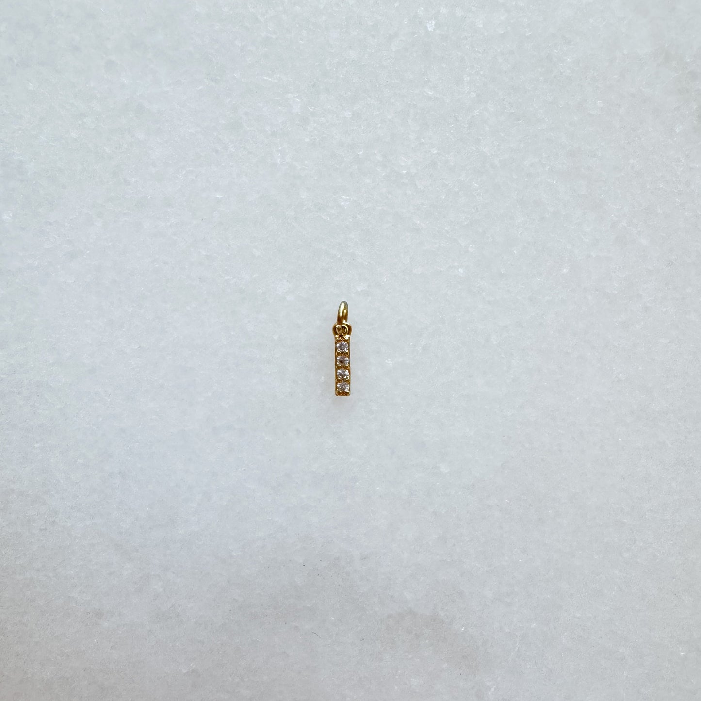 Diamond pavé initial charm set in gold, letter I