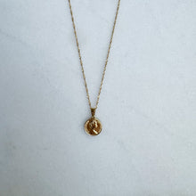 Load image into Gallery viewer, Gold necklace with a coin pendant on a white surface
