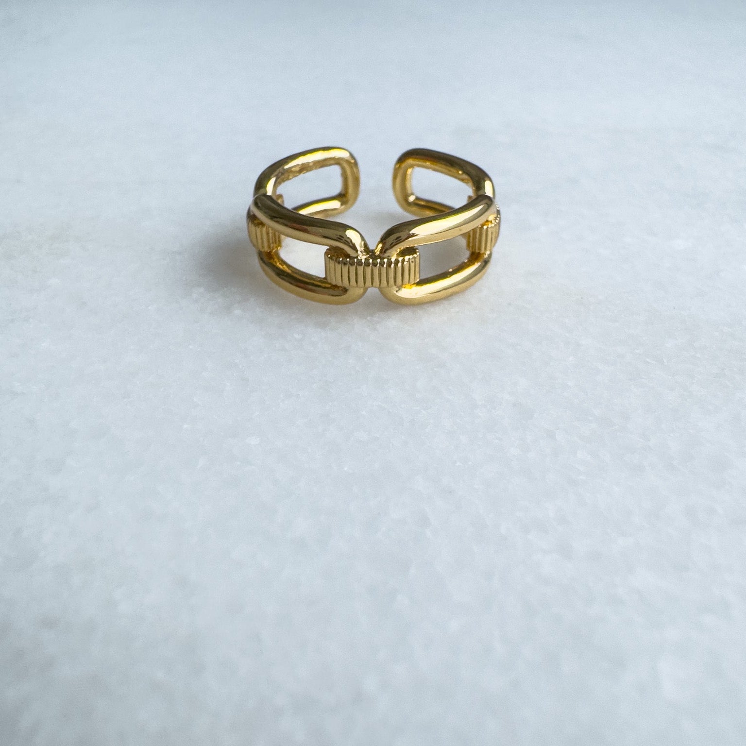 Gold link ring on a white background