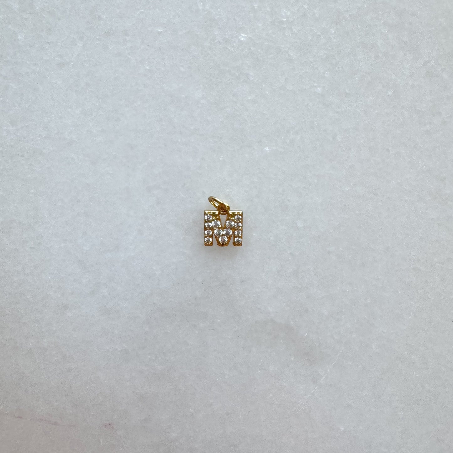 Diamond pavé initial charm set in gold, letter M