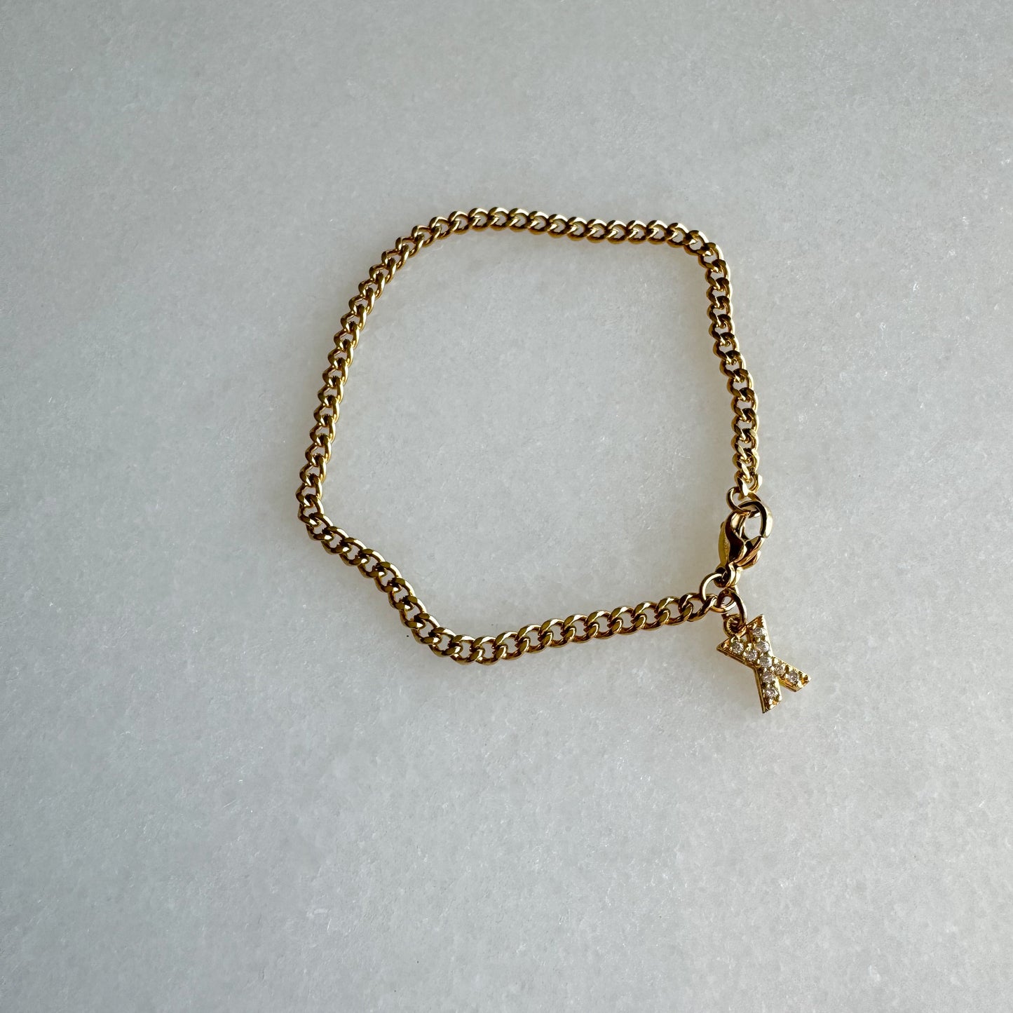 Gold cuban link bracelet with diamond pavé initial charm