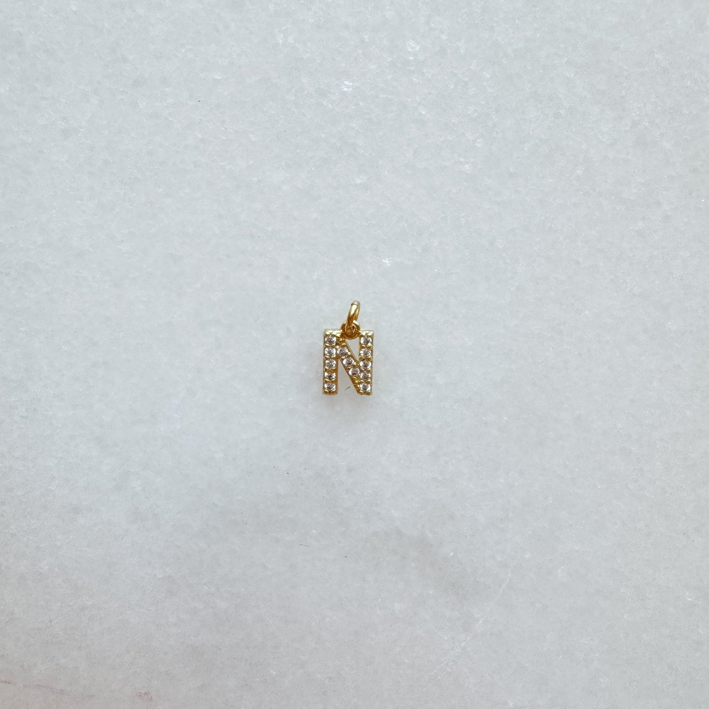Diamond pavé initial charm set in gold, letter N