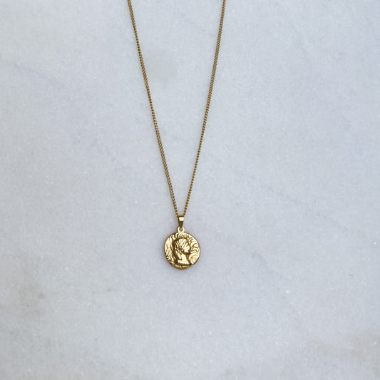 Gold chain with Native American coin pendant