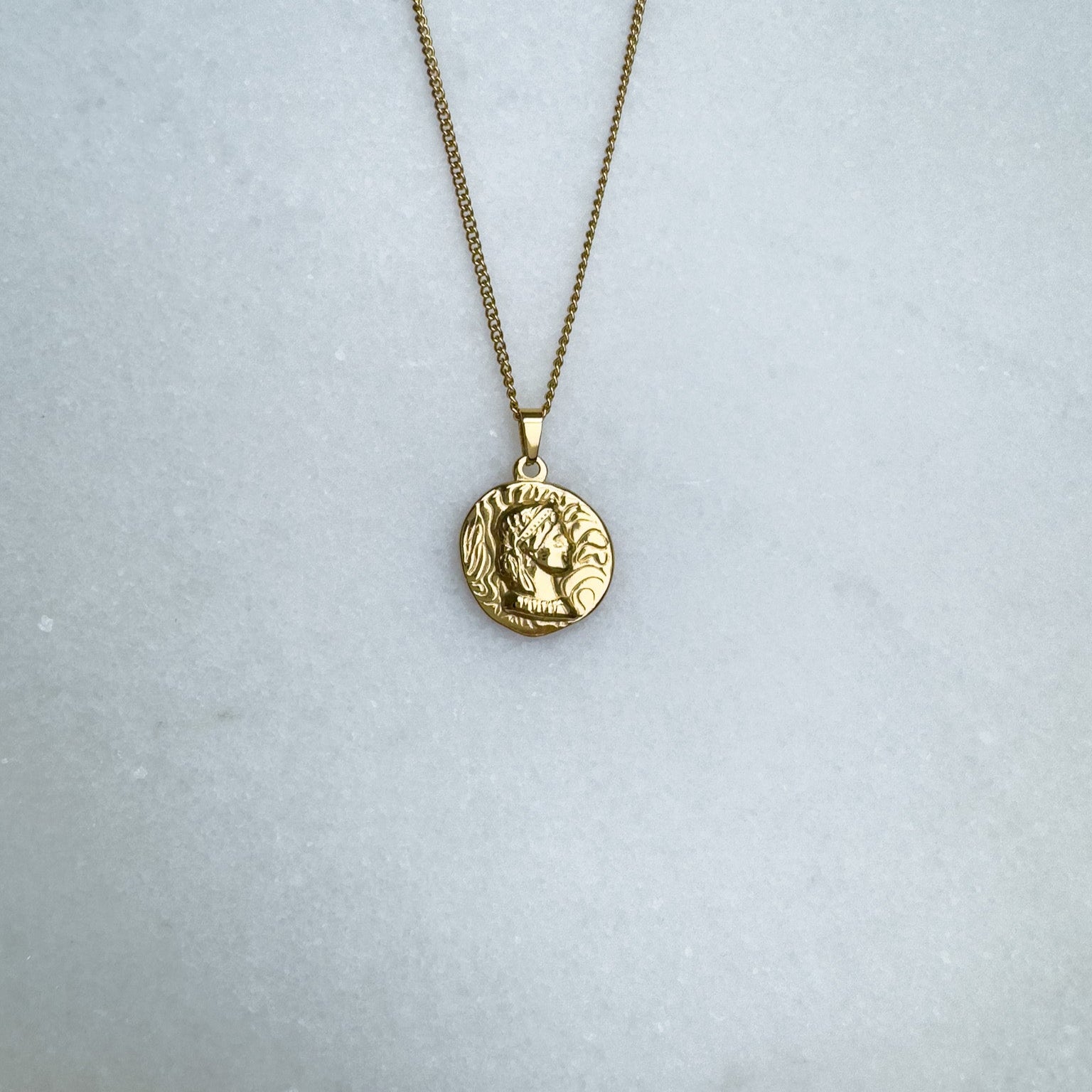 Gold chain with Native American coin pendant