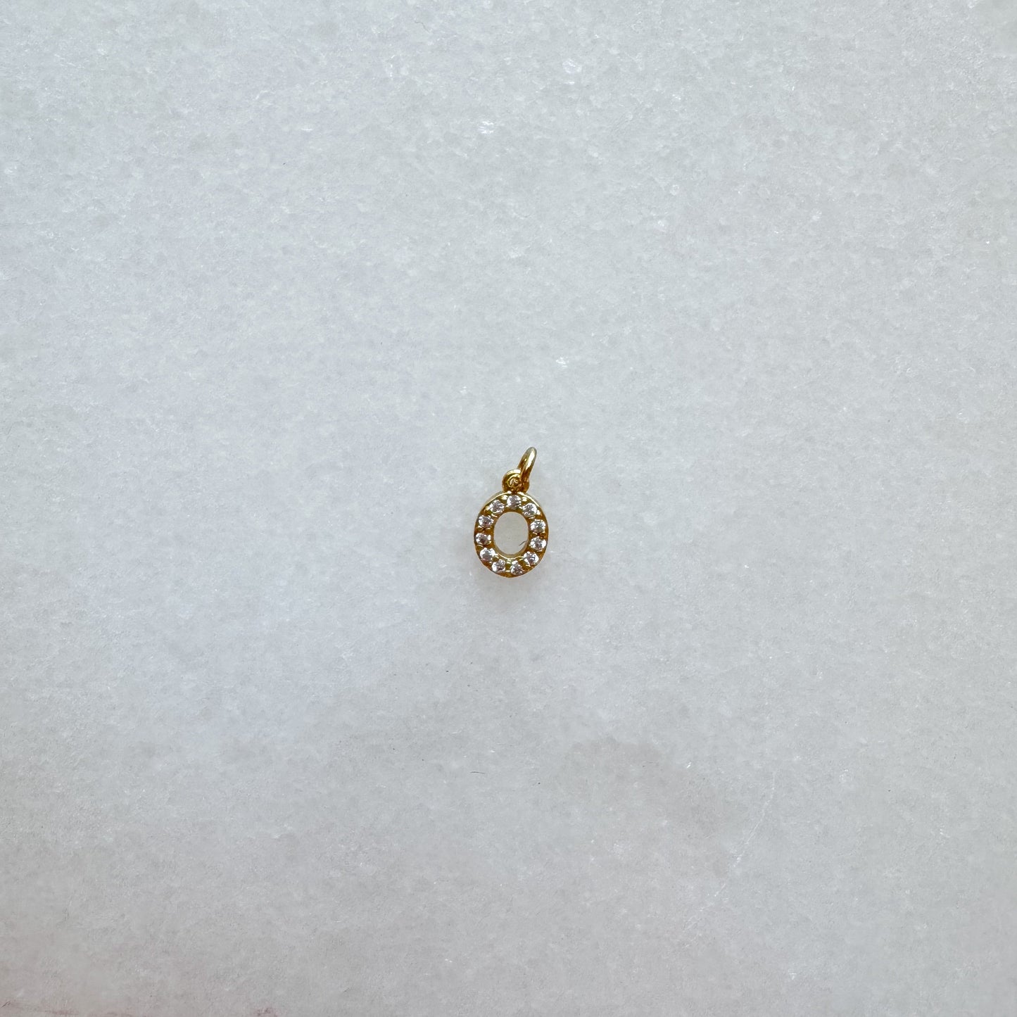 Diamond pavé initial charm set in gold, letter O