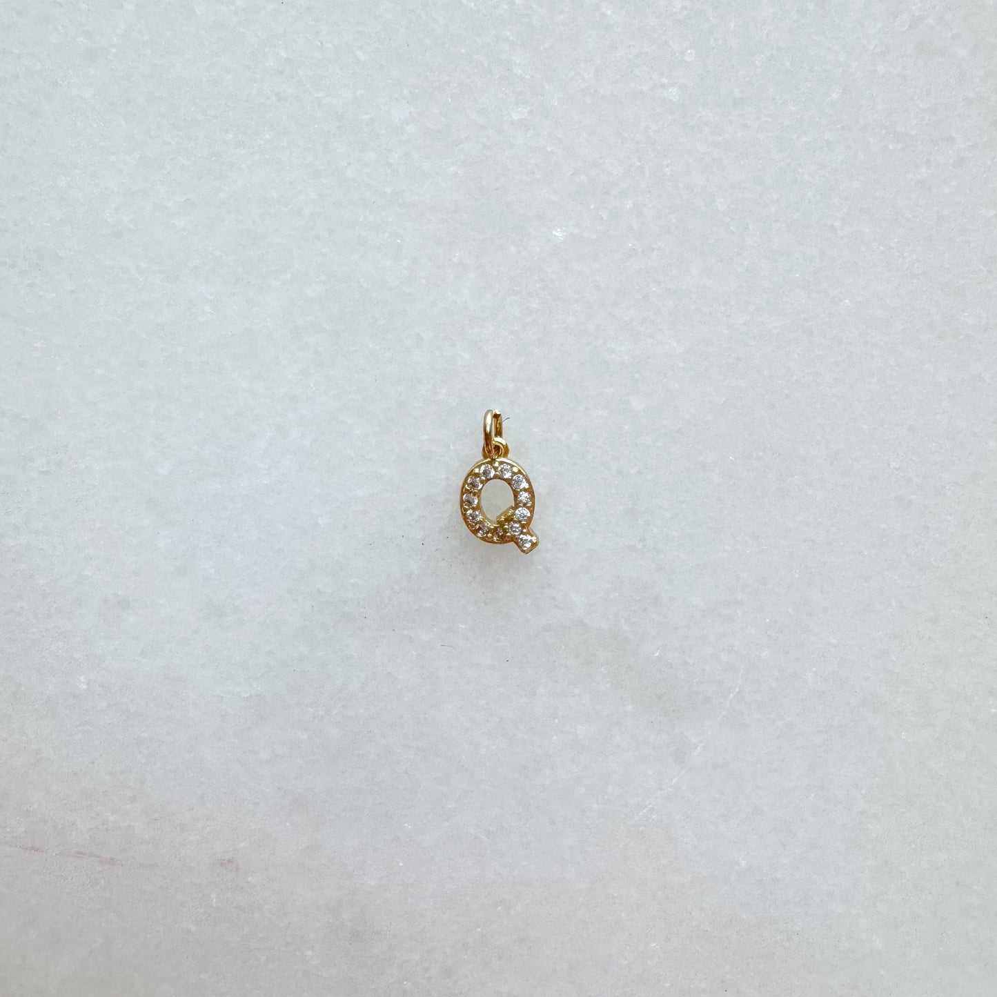 Diamond pavé initial charm set in gold, letter Q