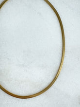 Load image into Gallery viewer, Close-up of a gold herringbone necklace white background
