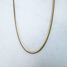 Load image into Gallery viewer, Gold herringbone chain necklace on a light gray background

