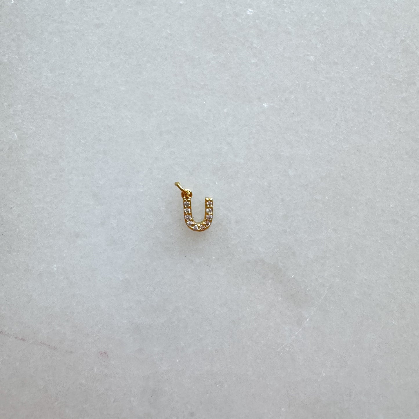 Diamond pavé initial charm set in gold, letter U