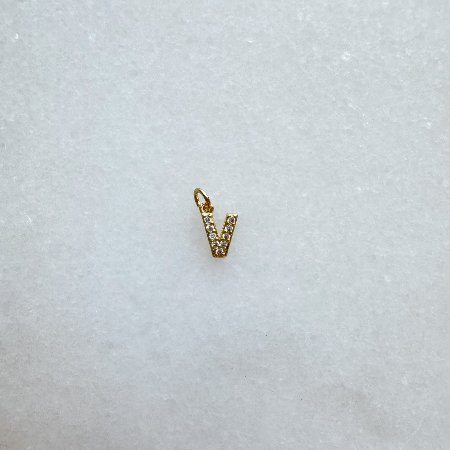 Diamond pavé initial charm set in gold, letter V