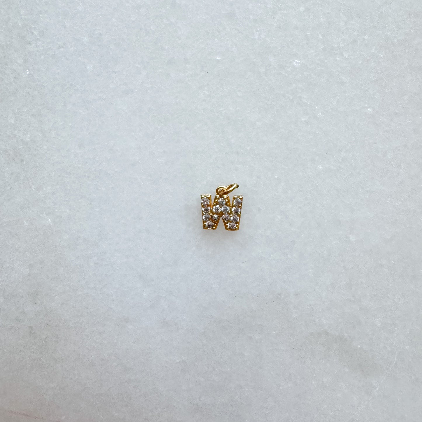 Diamond pavé initial charm set in gold, letter W