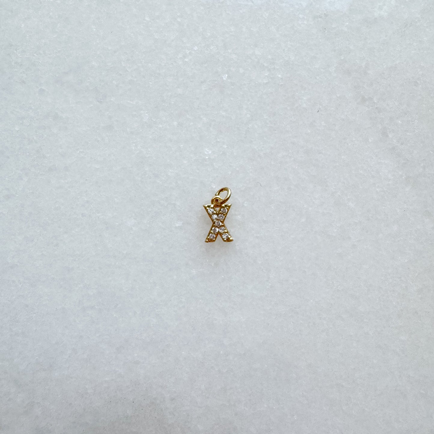 Diamond pavé initial charm set in gold, letter X