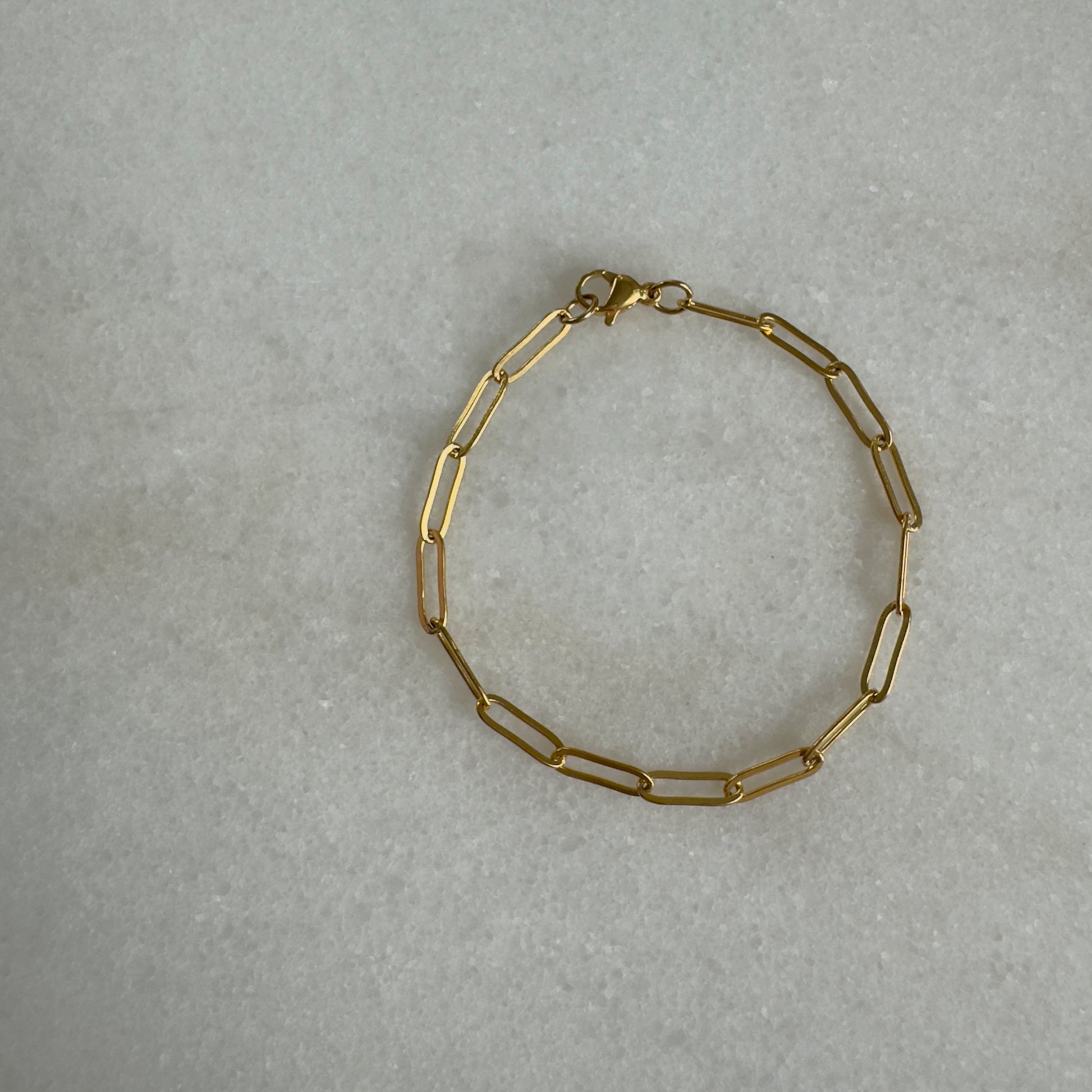 Gold Paperclip Bracelet on marble background