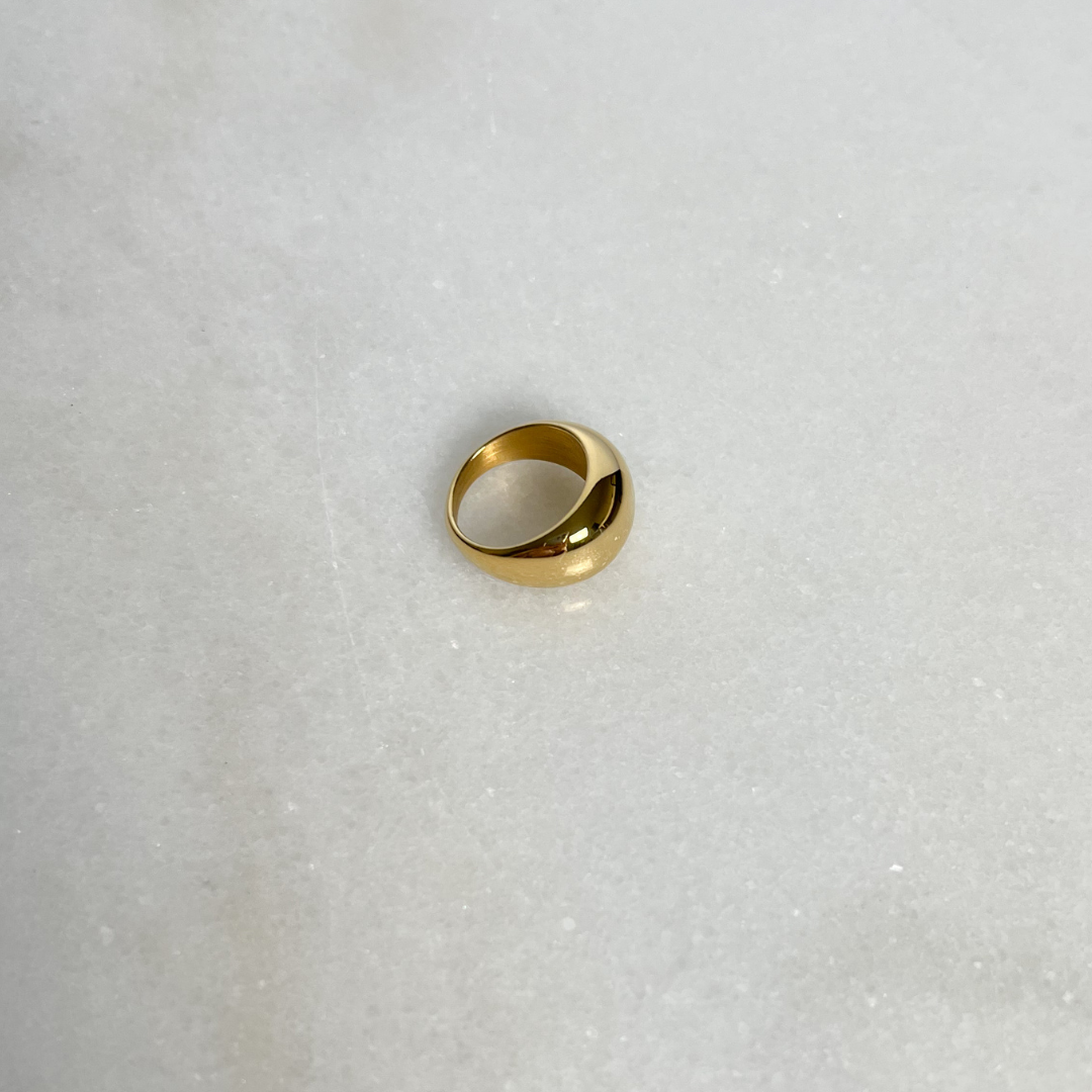 Gold Dome Ring on marble background