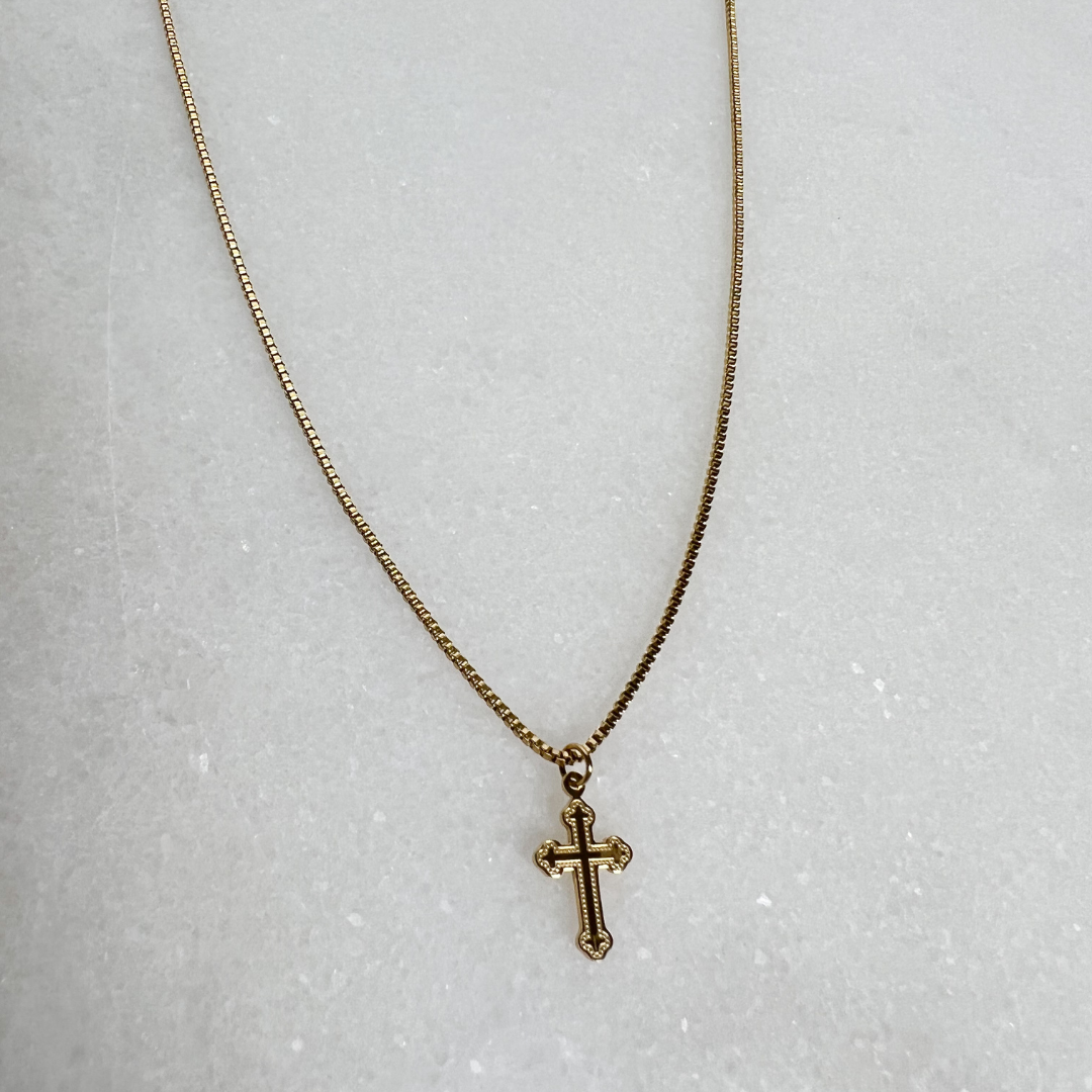Small Cross Pendant with Box Chain on marble background