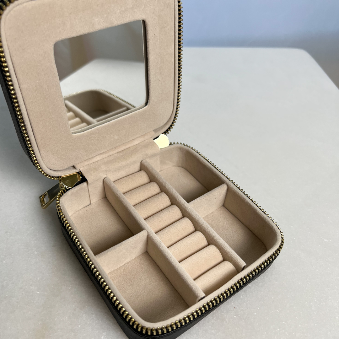 Open 4 inch x 4 inch Black Saffiano Leather Jewelry Travel Case with Gold Zipper Hardware showing compartments for rings and other jewelry