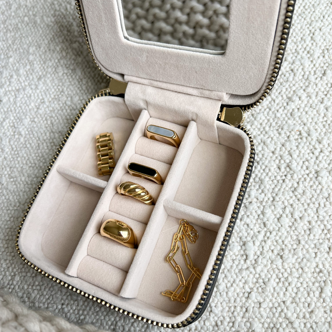 Open 4 inch x 4 inch Black Saffiano Leather Jewelry Travel Case with Gold Zipper Hardware filled with jewelry