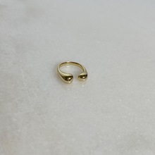 Load image into Gallery viewer, Gold u-shaped ring, rounded at the openings, on marble background.
