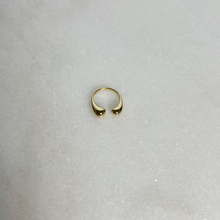 Load image into Gallery viewer, Gold u-shaped ring, rounded at the openings, on marble background.
