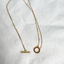 Load image into Gallery viewer, Unclasped Gold Double Chain Necklace with Toggle Clasp on white linen background
