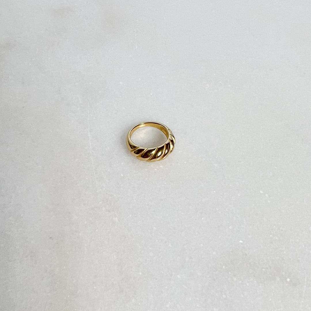 Gold Croissant Ring on marble background
